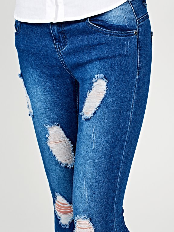 Distressed skinny jeans in mid blue wash