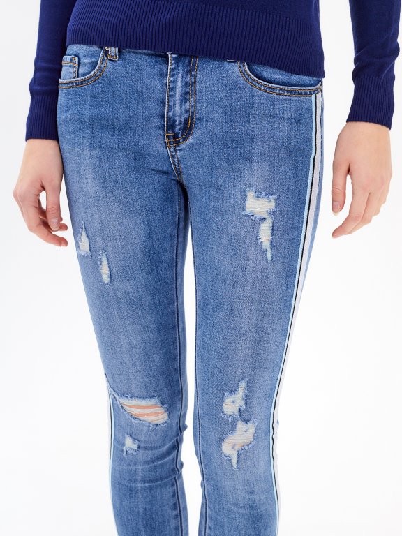 Taped skinny distressed jeans in mid blue wash