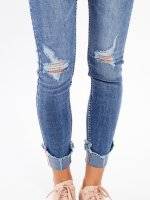 Skinny jeans with decorative tape on hem
