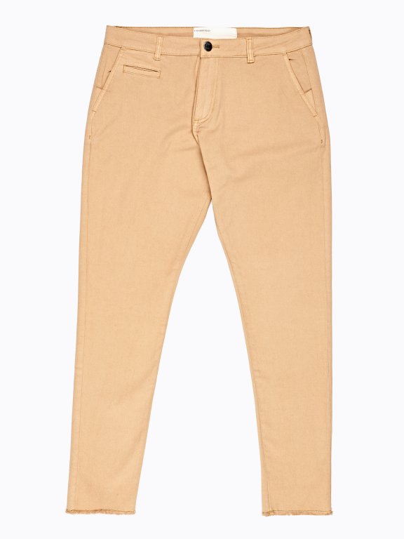 Stretch chinos with raw edges