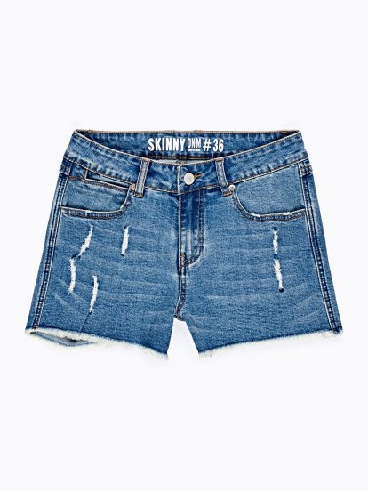Damaged skinny shorts in mid blue wash