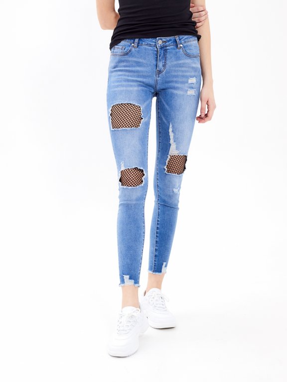 Destroyed skinny jeans with fishnet