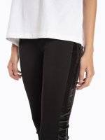 Skinny elastic knitted trousers with vinyl side stripe