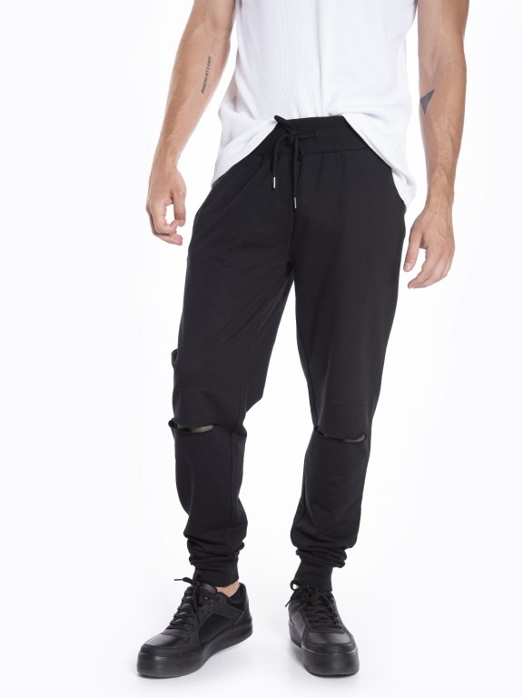 Distressed sweatpants with camo print patches