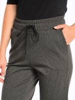 Striped sweatpants with metal rivets on ham