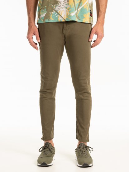Stretch chinos with raw edges
