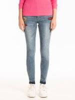 Skinny jeans with patches and raw edges