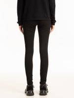 Knitted slim trousers with faux leather side stripe