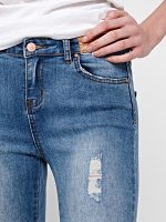 DISTRESSED SKINNY JEANS WITH ANKLE ZIPPERS