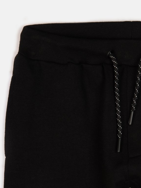 Sweatpants with mesh and reflective print