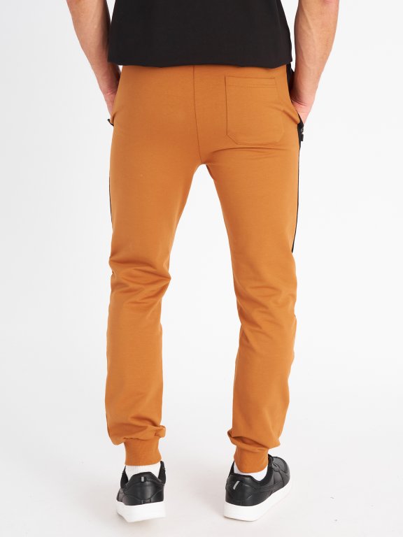 Męskie spodnie dresowe z elementami odblaskowymi na kieszeniach
